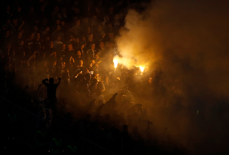 Illustration for article titled Smoke, Flares, Riot Police In Belgrade Derby Make For Haunting Photos